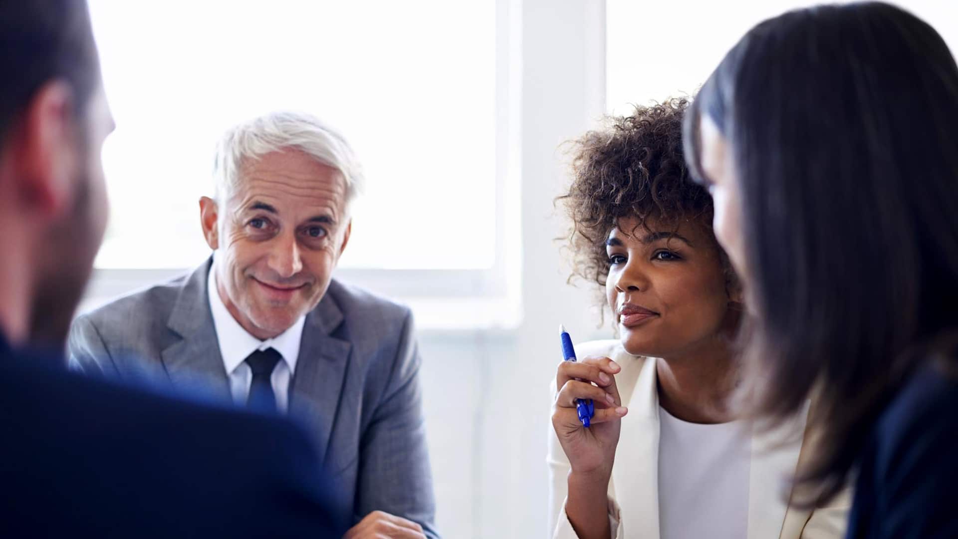 HR > Header > Background Business professionals taking part in a group discussion during a workplace training session.